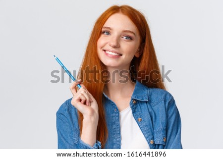 Close-up portrant attractive talented redhead girl got inspired want draw something, holding colored pencil, studying art at online courses, smiling, standing white background joyful Royalty-Free Stock Photo #1616441896