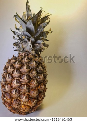Pineapple, ripe fruit on a light background.