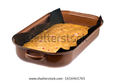 A baked cake on a kitchen bench, isolated white
