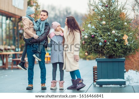 Family on Christmas Fair at winter day outdoors