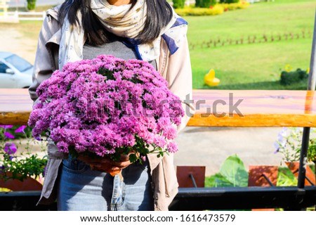 Young woman having a bouque of flowers A chrysanthemum