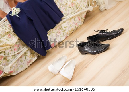 Wedding night. Disrobed wedding clothes, suit and shoes near a bed Royalty-Free Stock Photo #161648585