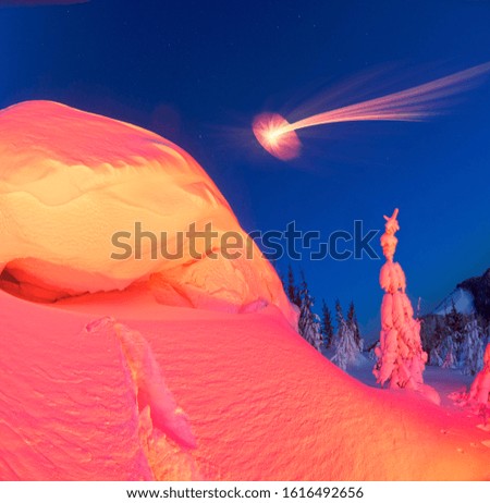 snow cornice at the top is a snow formation formed in the mountains under the influence of wind. Artistic illumination has created a fabulous fiction picture