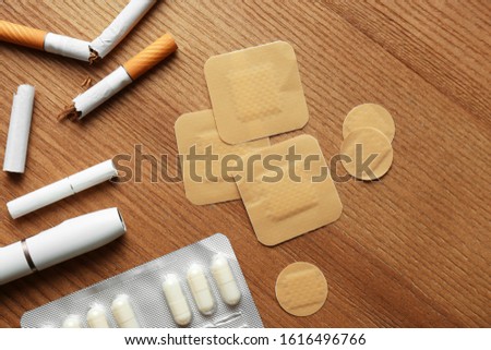 Flat lay composition with nicotine patches on wooden table Royalty-Free Stock Photo #1616496766