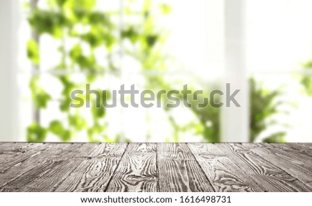 Empty wooden table in front of window. Sunny morning 