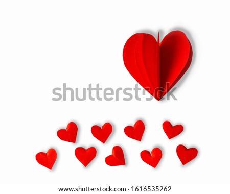 red paper hearts on a white background. Valentine's day holiday. Symbol of love.