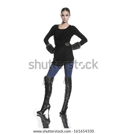 Full body portrait of a beautiful young female standing posing in studio