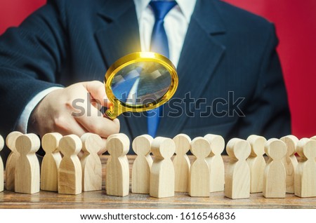 Man studying a crowd of people with a magnifying glass. Market and customers research. Hr search candidates for work, staff recruiting. Society, demographic. Citizens electorate. Analysis Royalty-Free Stock Photo #1616546836
