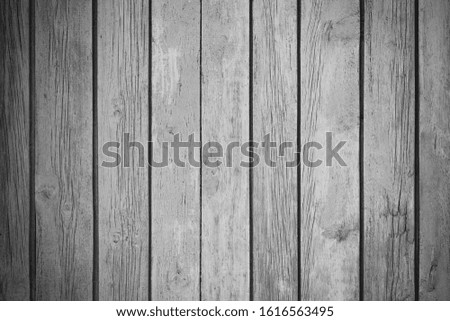 black and white photo of a wooden texture with peeling paint, with a vignetting effect