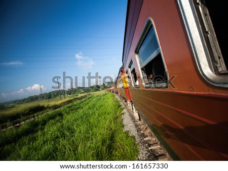 Train on a curved railroad in a sunny day. Sri Lanka