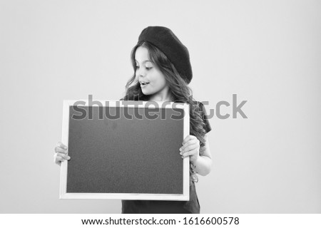 Interesting lesson. big sales. child on yellow wall. back to school. Interesting info. information board. Fashion news. happy girl in french beret. small girl kid with school backboard, copy space.