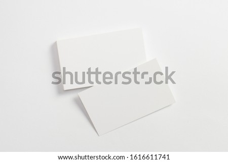Top view of blank business cards isolated on white. Mock-up to showcase your design.