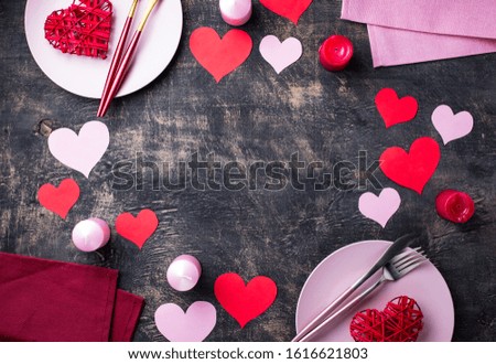 Valentines Day table setting in pink and red color on black background