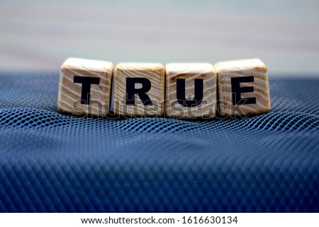 concept word true on wooden cubes on a beautiful light background