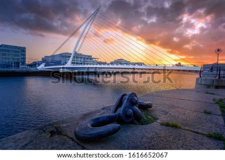 Amazing sunset and golden hour at Samuel Beckett bridge, resembling a harp. Fine art photography of Dublin cityscape, Ireland