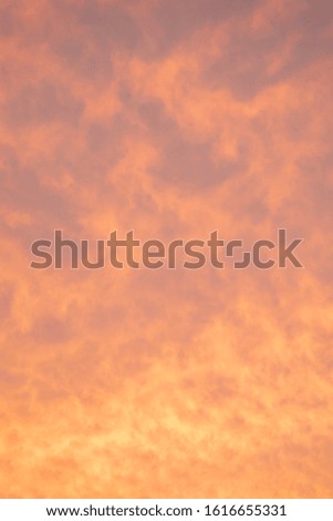 A orange cloud texture of a sunset that is rippled