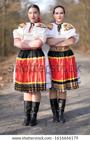 two Young beautiful slovak girls in traditional costume 