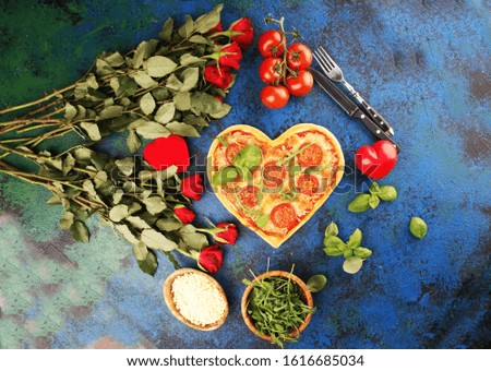 pizza Heart shaped margherita with tomatoes and mozzarella vegetarian. Food concept of romantic love for Valentines Day.