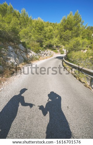 Marseille, France - August 12th, 2019. Natural picture of the national park of the calanques of Marseille, Provence region. A lovely couple is having fun with their shadows.