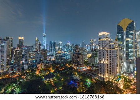 Highlight and shadow of Bangkok city at night. This area is an important business and banking center. With long exposure photography create moving cloud in the sky.With haze and smoke effect.