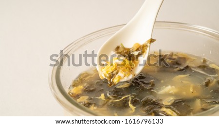 Seaweed egg flower soup in glass bowl on pure white background