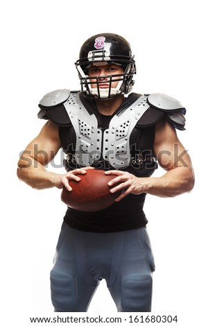 American football player with ball wearing helmet and protective shields 