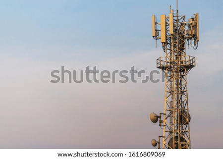 Communication Tower with Parabolic and GSM Antennas on blue sky background with copy space.