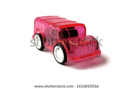 a pink car toy on white surface