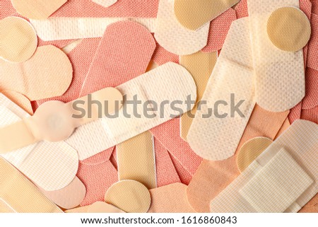 Different medical sticking plasters as background, closeup. First aid item