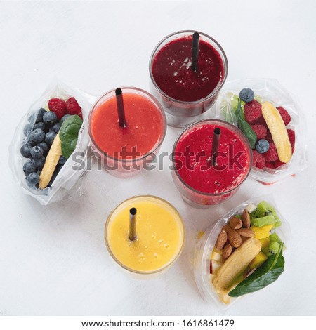 Htalthy fresh fruit and vegetable smoothies with assorted ingredients served in packs. Top view 