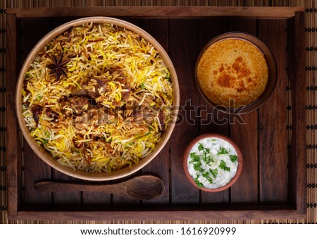 Delicious Hyderabadi mutton biryani top view Royalty-Free Stock Photo #1616920999