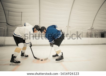 Hockey players playing on the ice.