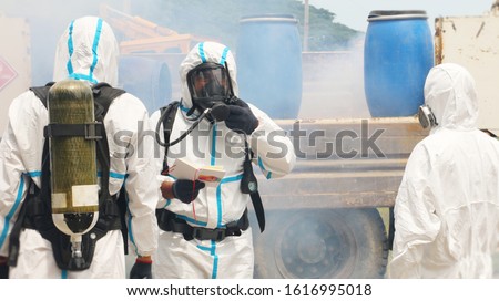 Firemen attending an emergency action plan and safety management training in case of chemical leaking.