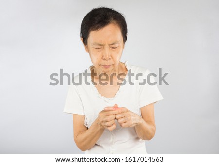 old asian woman feel finger bone pain