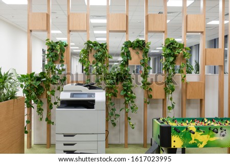 Office space interior with green plant corner for relaxing/ Greens in workspaces/ Winter garden in room/ Healthy lifestyle, tree lover and gardening concept Royalty-Free Stock Photo #1617023995