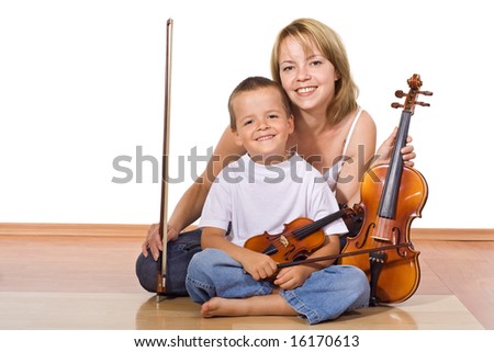 Woman and little boy sitting on the floor with violins - isolated
