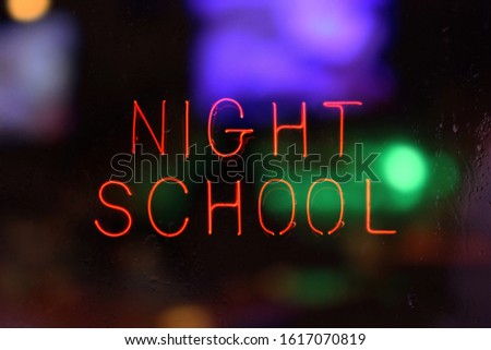 Night School Neon Sign in Rainy Window