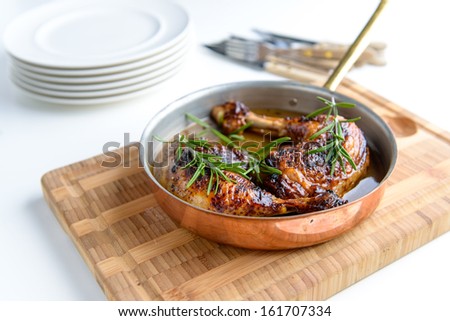 Tasty fresh Chicken bone in a copper pan with some herbs on the side Royalty-Free Stock Photo #161707334