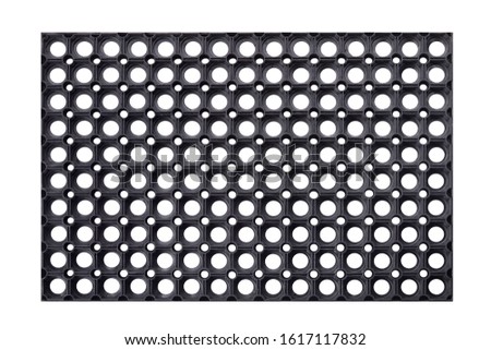 Black rubber entrance mat isolated on white background. Cellular rubber mat for dirt removal. Welcome carpet, close up Royalty-Free Stock Photo #1617117832