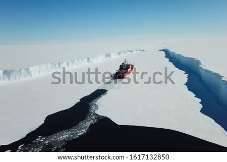 a Ice enpalled naldo, ice breaking ship. Royalty-Free Stock Photo #1617132850