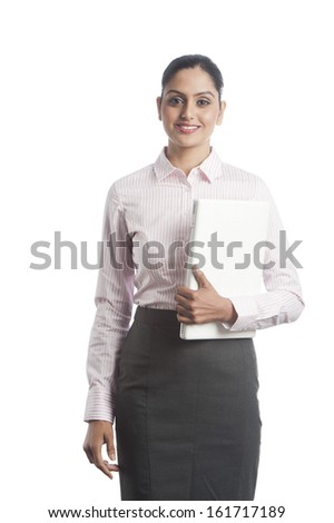 Businesswoman holding a laptop and smiling