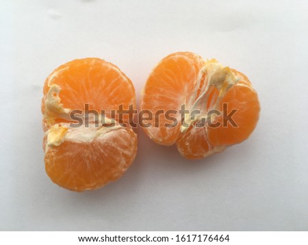 halves of tangerine on a white background