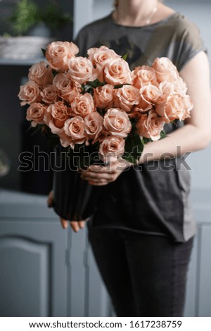 Bright pink spray roses in female hands 