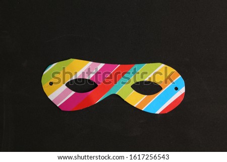 Party cardboard mask on colorful background