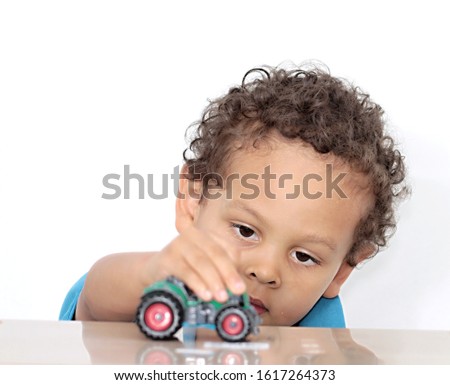 boy playing with toy tractor on white background stock photo