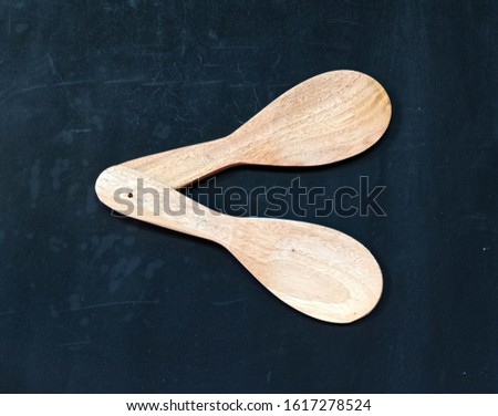 The letter C is made of two wooden rice spoons.