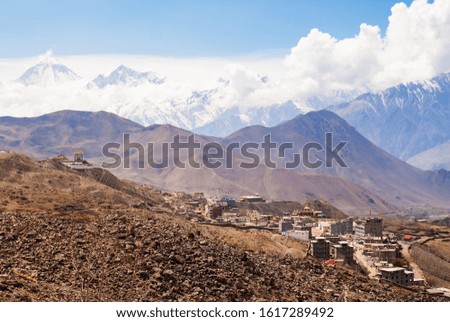 Picture of tibetan village in Himalaya mountains with snowy peak on background. Mountaint trekking, hiking and climbing in Nepal
