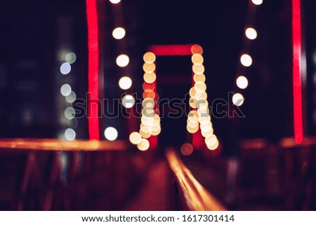 blurred bokeh festival night light of city. abstract colourful evening string light bulb background.