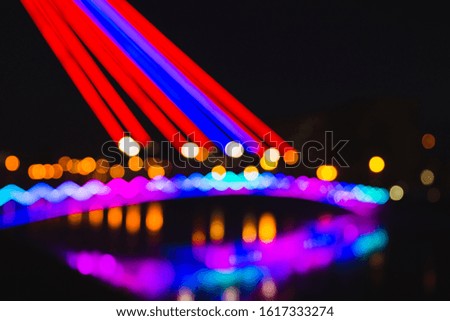 Abstract defocused background of colorful city lights at night. Blurry backdrop