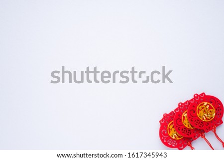 Chinese New Year decorations with white background with assorted festival decorations. Chinese characters means abundant of wealth, prosperity and luck. Flat lay or top view.